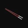 Set of two red Chinese chopsticks and chopsticks rests