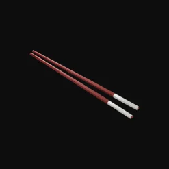 Set of two red Chinese chopsticks and chopsticks rests
