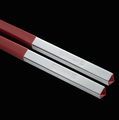Set of two red Chinese chopsticks and chopsticks rests
